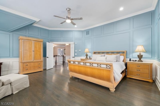 bedroom with dark wood-type flooring, visible vents, a decorative wall, and crown molding