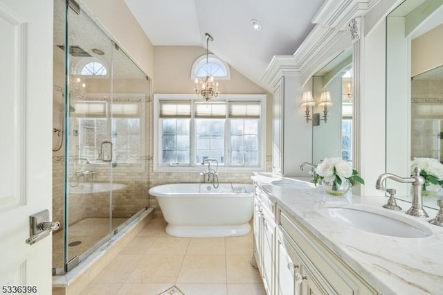 full bath with lofted ceiling, plenty of natural light, a sink, and tile patterned floors