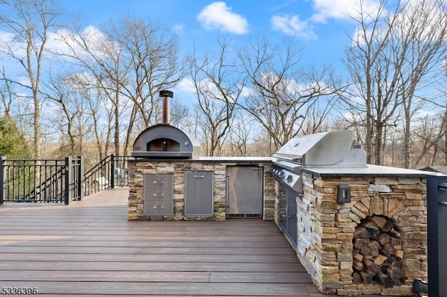 wooden terrace with grilling area and exterior kitchen