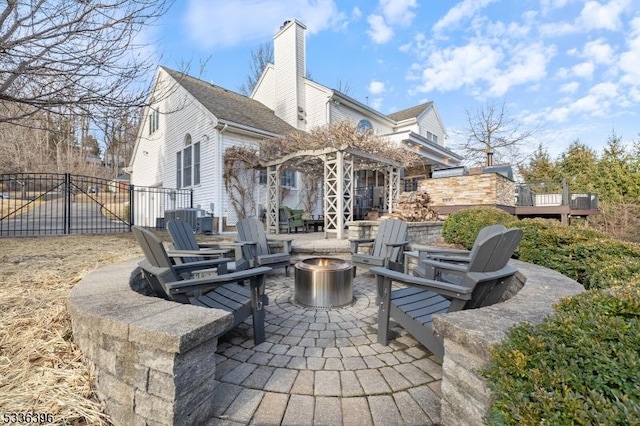 view of patio featuring fence and a fire pit