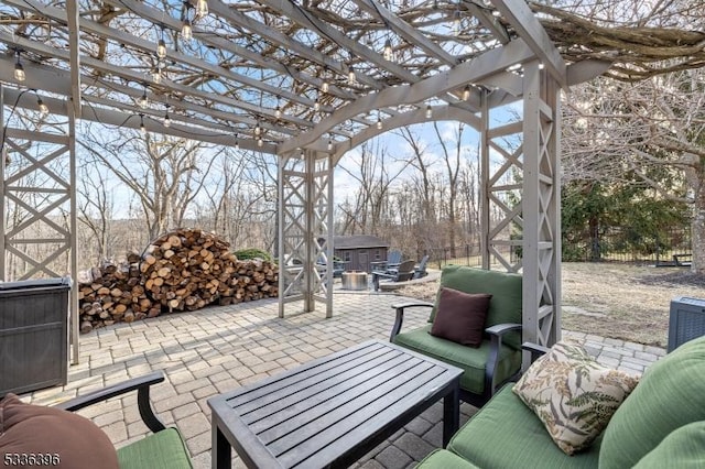 view of patio / terrace featuring a storage unit, a pergola, and an outdoor structure