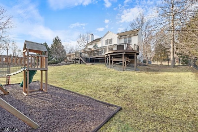 exterior space featuring a deck, a playground, and fence