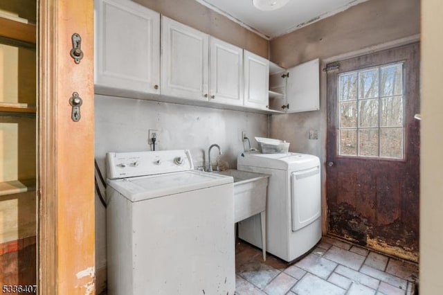 laundry room featuring independent washer and dryer and cabinets