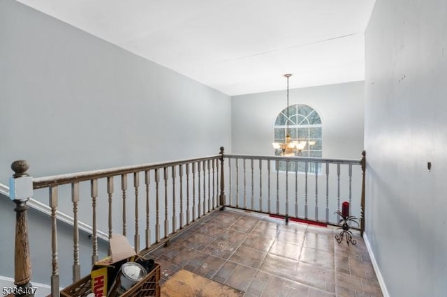 hallway with an inviting chandelier