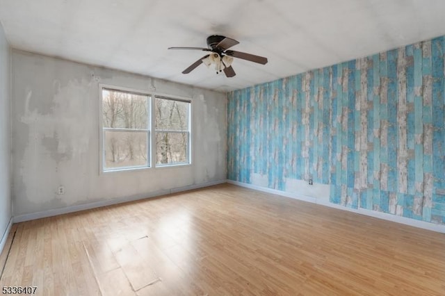 spare room with light hardwood / wood-style floors and ceiling fan