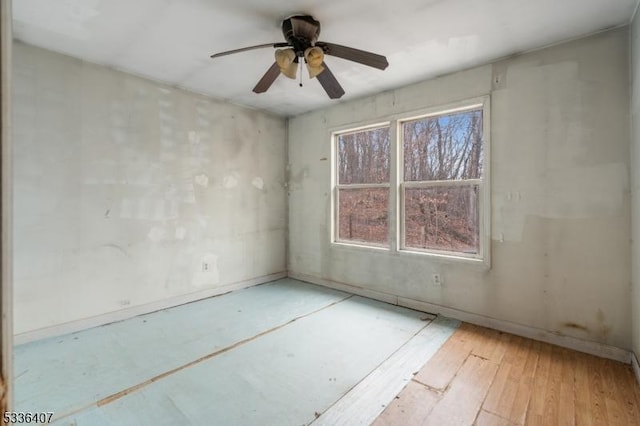 empty room featuring ceiling fan and light hardwood / wood-style floors