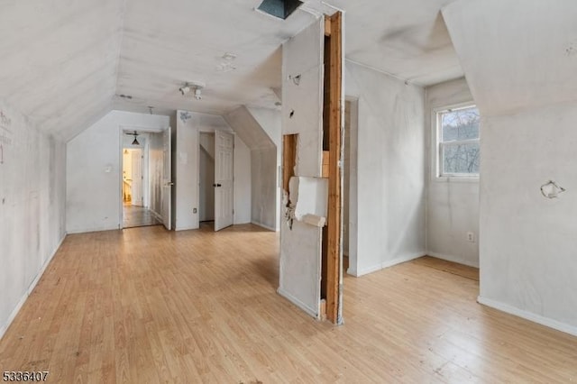 bonus room featuring lofted ceiling and light hardwood / wood-style floors