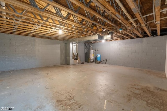 basement featuring heating unit and water heater