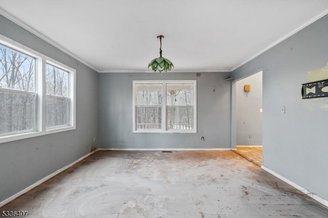 empty room featuring crown molding