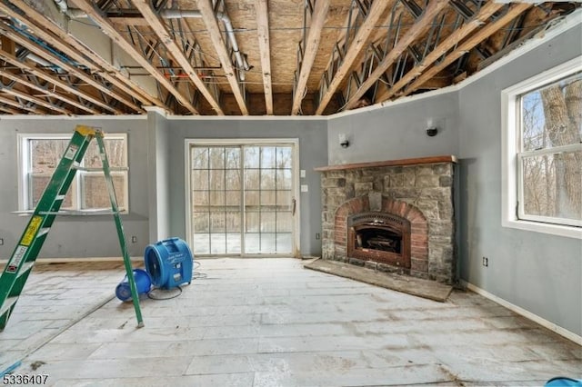 unfurnished living room with a healthy amount of sunlight and a fireplace