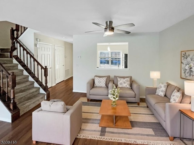 living room with dark hardwood / wood-style floors and ceiling fan