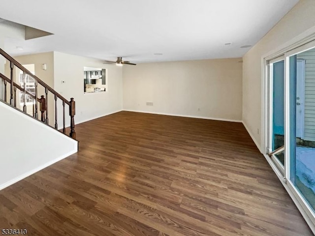 unfurnished living room featuring ceiling fan and dark hardwood / wood-style floors