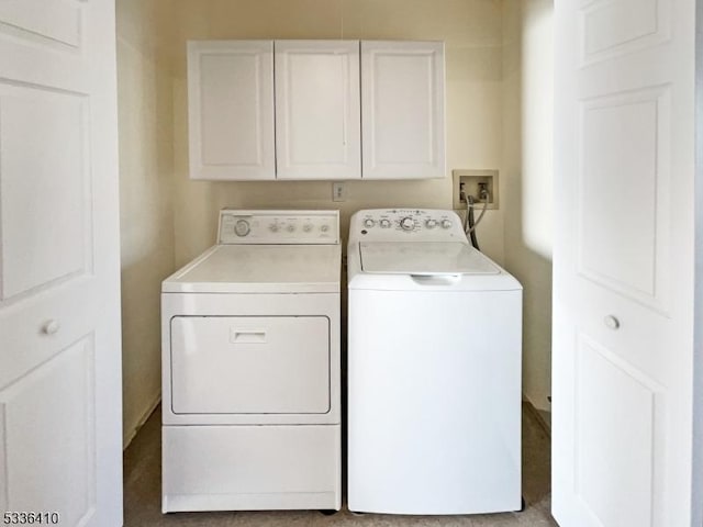 washroom featuring cabinets and separate washer and dryer