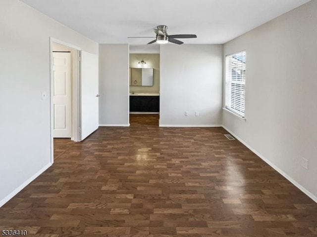 empty room featuring ceiling fan and dark hardwood / wood-style flooring