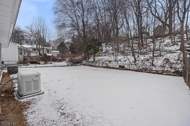 yard covered in snow with a wooden deck