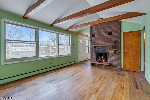 unfurnished living room featuring a baseboard heating unit, wood-type flooring, lofted ceiling with beams, and a brick fireplace