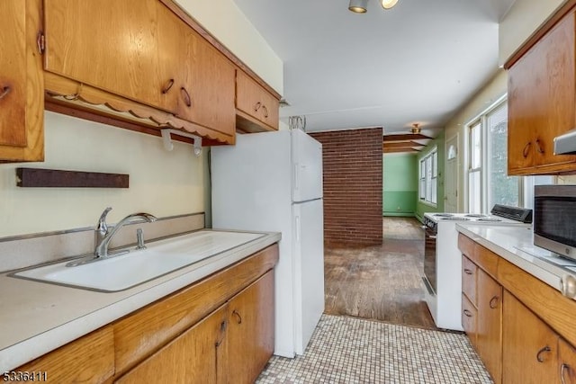 kitchen featuring sink and white appliances