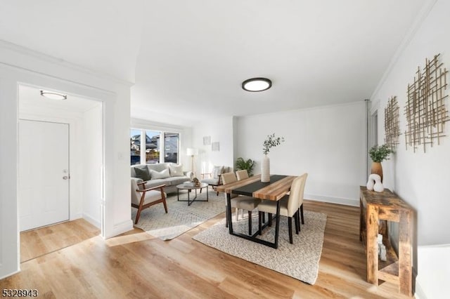 dining room featuring hardwood / wood-style floors and ornamental molding