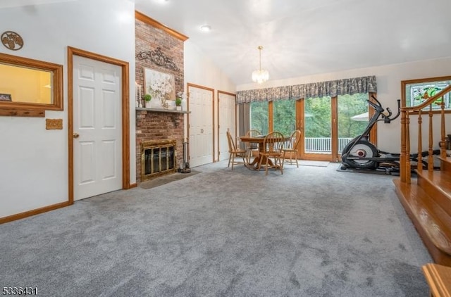 interior space featuring carpet floors, a fireplace, plenty of natural light, and a chandelier