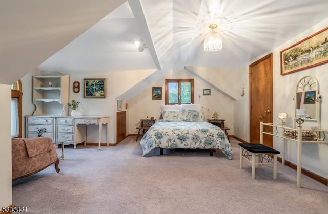 bedroom featuring vaulted ceiling and carpet