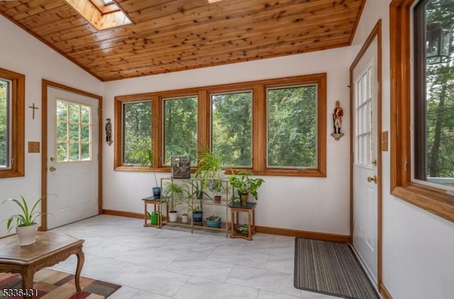 sunroom / solarium featuring vaulted ceiling with skylight and wood ceiling