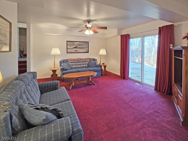 carpeted living room with ceiling fan