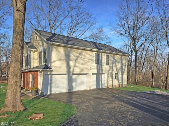 view of home's exterior featuring a garage and a yard