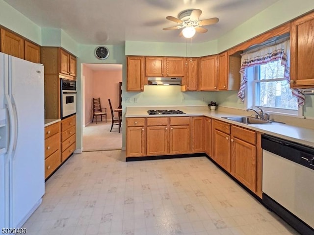 kitchen with sink, white appliances, and ceiling fan