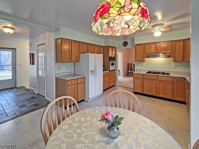 kitchen featuring ceiling fan and white appliances