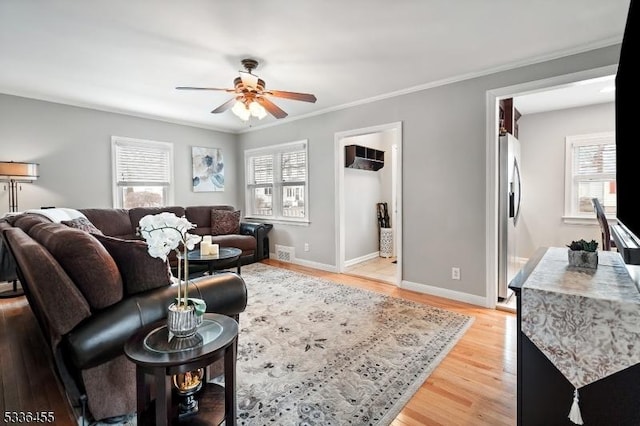 living room featuring ornamental molding, hardwood / wood-style floors, and ceiling fan