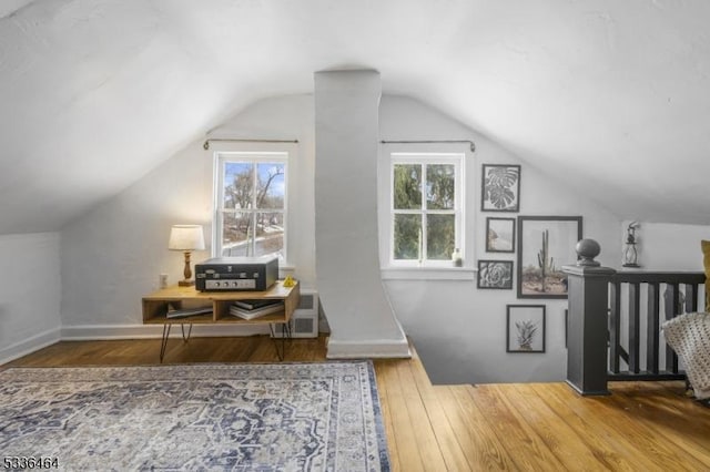 bonus room featuring vaulted ceiling and hardwood / wood-style floors