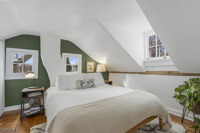 bedroom featuring hardwood / wood-style flooring and vaulted ceiling