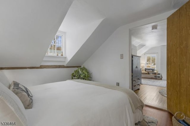 bedroom featuring lofted ceiling and light hardwood / wood-style flooring