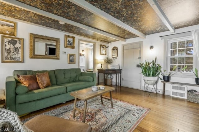 living room with hardwood / wood-style floors and beamed ceiling