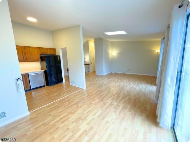 unfurnished living room featuring lofted ceiling and light hardwood / wood-style flooring