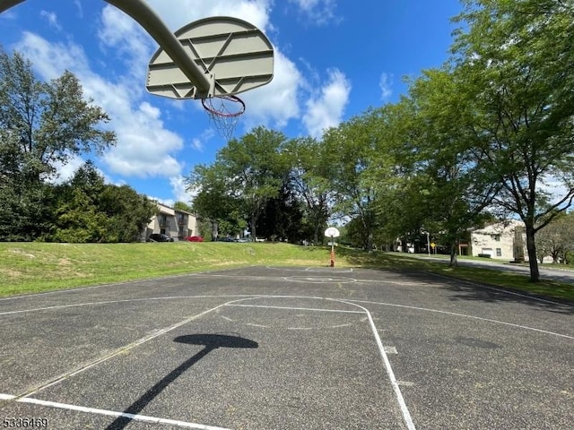 view of basketball court with a lawn