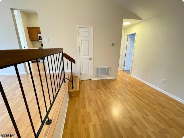 interior space featuring light hardwood / wood-style flooring and high vaulted ceiling