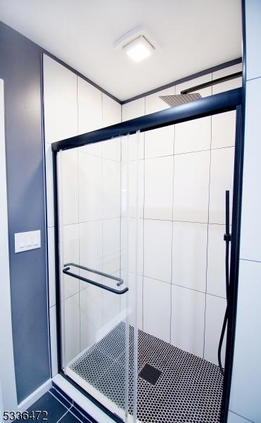 interior space featuring a shower with door