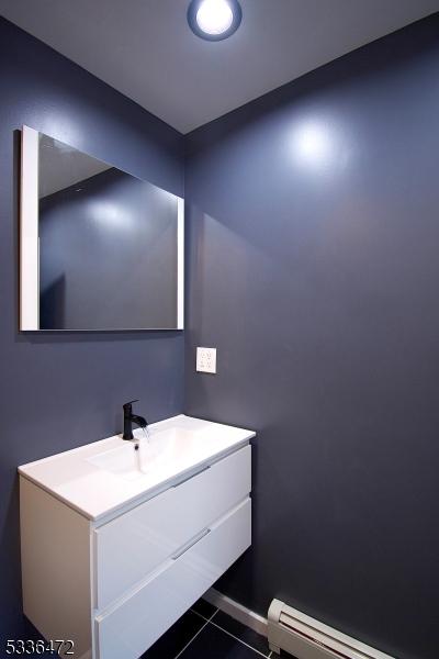 bathroom featuring a baseboard radiator, vanity, and tile patterned floors