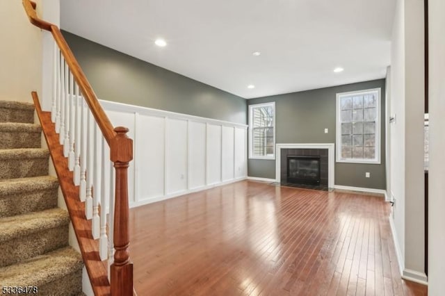 unfurnished living room featuring wood-type flooring and a fireplace