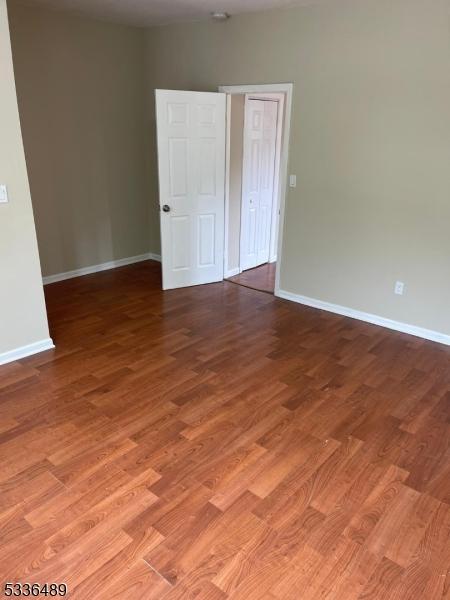 spare room featuring light wood finished floors and baseboards