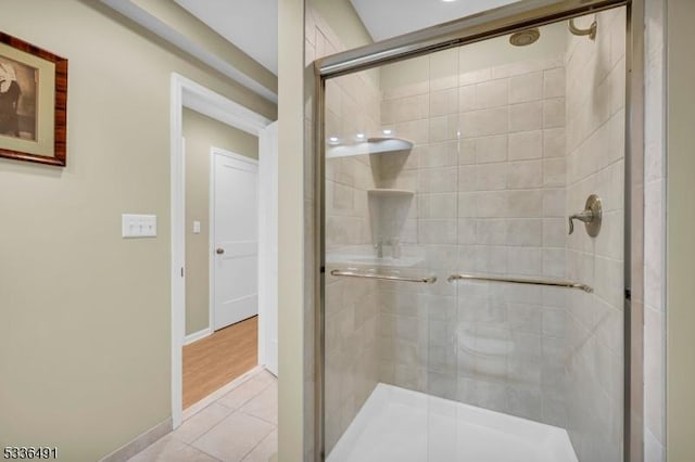 bathroom with walk in shower and tile patterned floors