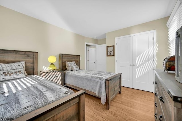 bedroom with a closet and light wood-type flooring