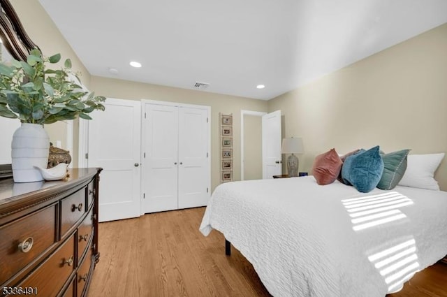 bedroom with a closet and light hardwood / wood-style flooring