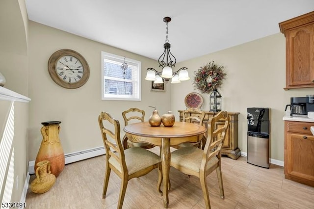 dining space with a baseboard radiator, an inviting chandelier, and light wood-type flooring