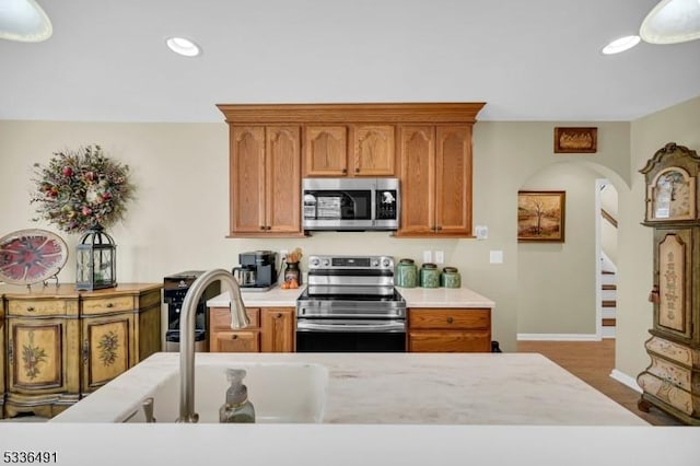 kitchen with hardwood / wood-style floors and appliances with stainless steel finishes