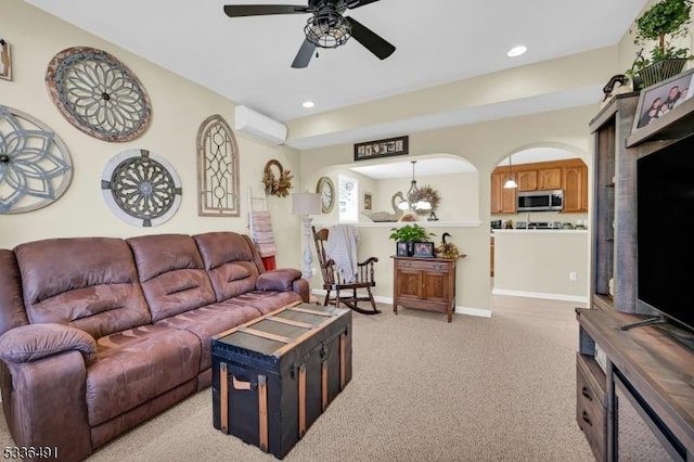 carpeted living room with ceiling fan with notable chandelier and an AC wall unit