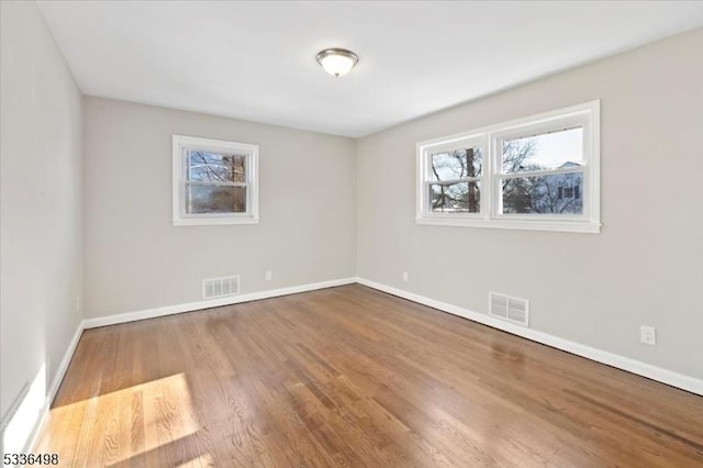 empty room with hardwood / wood-style flooring