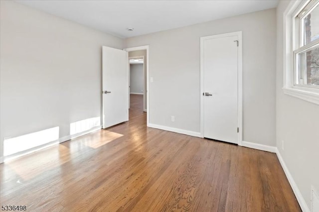 unfurnished bedroom with light wood-type flooring