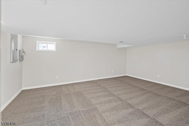 basement featuring carpet flooring and electric panel